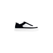 Black and white platform sneaker with velcro strap, textured upper material.