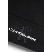 Black calvin klein jeans with monogram logo on the leg.
