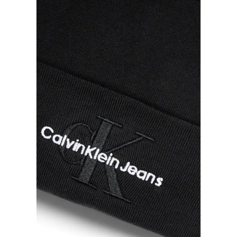 Black calvin klein jeans with monogram logo on the leg.