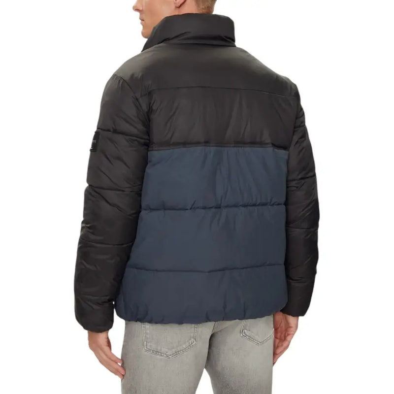 Black and navy blue puffer jacket with quilted design, made of synthetic material.