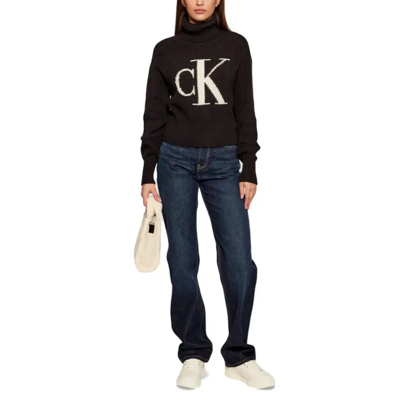 Calvin Klein Jeans black ribbed knit turtleneck sweater for women with large white ck logo on the chest