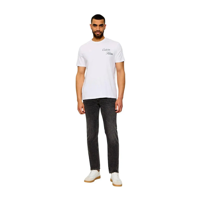 White calvin klein t-shirt with subtle black cursive logo paired with beige cotton classic fit jeans for men