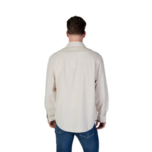 Beige long-sleeved cotton button-up shirt with classic collar and folded cuffs from Calvin Klein Jeans men spring summer collection