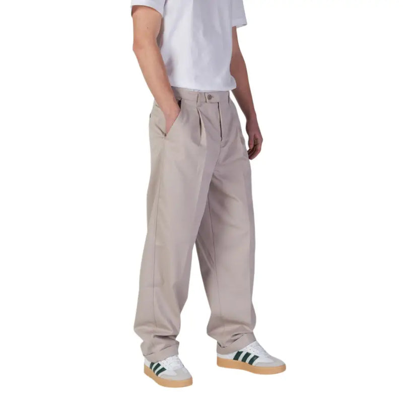 Beige pleated chino pants with relaxed fit and button closure from calvin klein jeans men spring summer collection