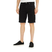 Black denim shorts with rolled hem and button fly design.