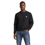 Calvin Klein Sweat-shirt noir en coton à col rond pour homme, orné d'un petit logo blanc sur la poitrine gauche.