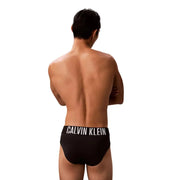 Calvin Klein Jeans, slip de bain noir pour homme en polypropylène avec bande logo blanche, vue de face
