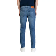 Jean Calvin Klein pour homme, en denim de coton bleu, coupe slim classique, avec empiècement en cuir marron à la ceinture (vue de dos).