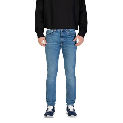 Jean Calvin Klein pour homme, en denim bleu, avec poche zippée, référence LV04RB719G, coupe droite classique et délavage subtil.