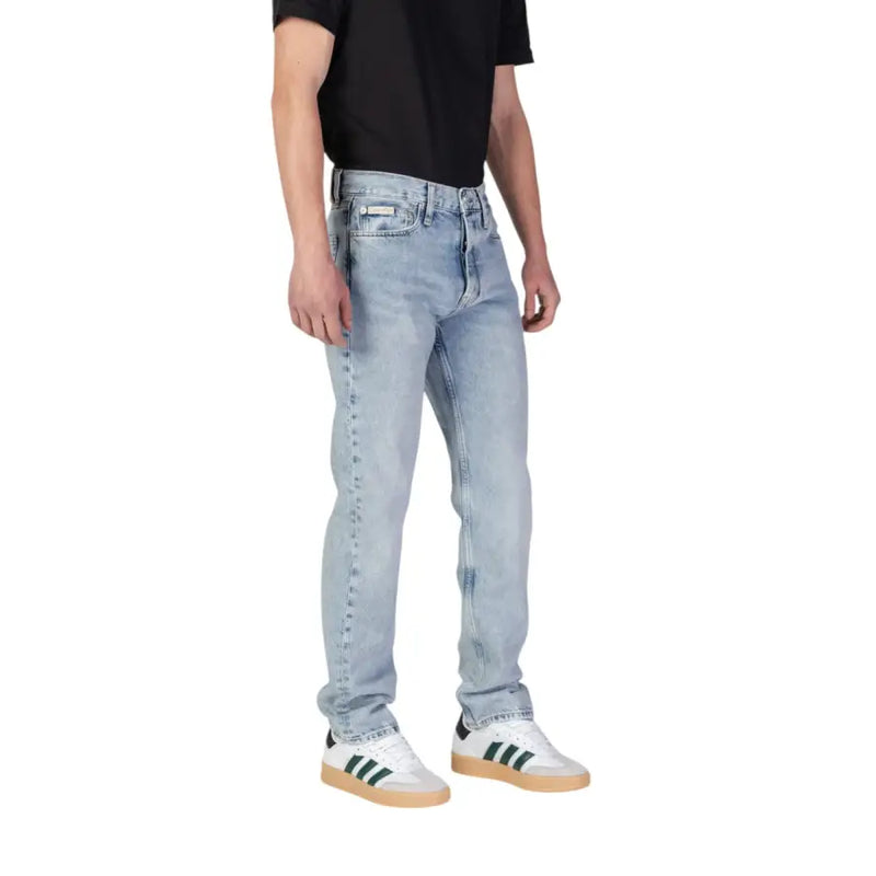 Jean Calvin Klein pour homme, bleu, en coton biologique, avec un délavage clair, une coupe cinq poches et un léger effet délavé aux cuisses.