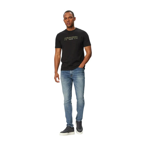 Black Calvin Klein t-shirt with white text logo paired with blue stretch denim jeans cotton blend for men