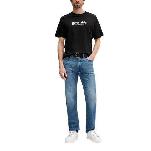 Black calvin klein cotton t-shirt with white logo text paired with blue zip pocket cotton jeans for men