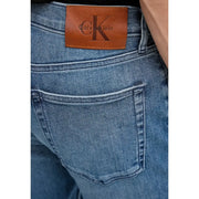 Back side view of men blue cotton denim jeans with a zip pocket and brown leather Calvin Klein brand patch
