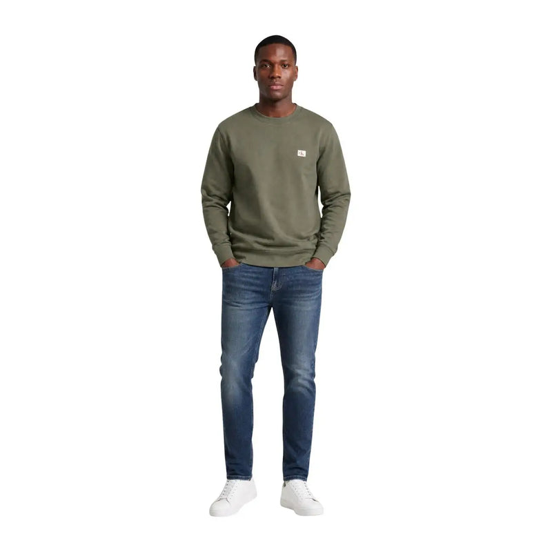 Calvin Klein Jeans Sweat-shirt vert en coton pour homme, col rond, avec un petit logo blanc sur la poitrine gauche.