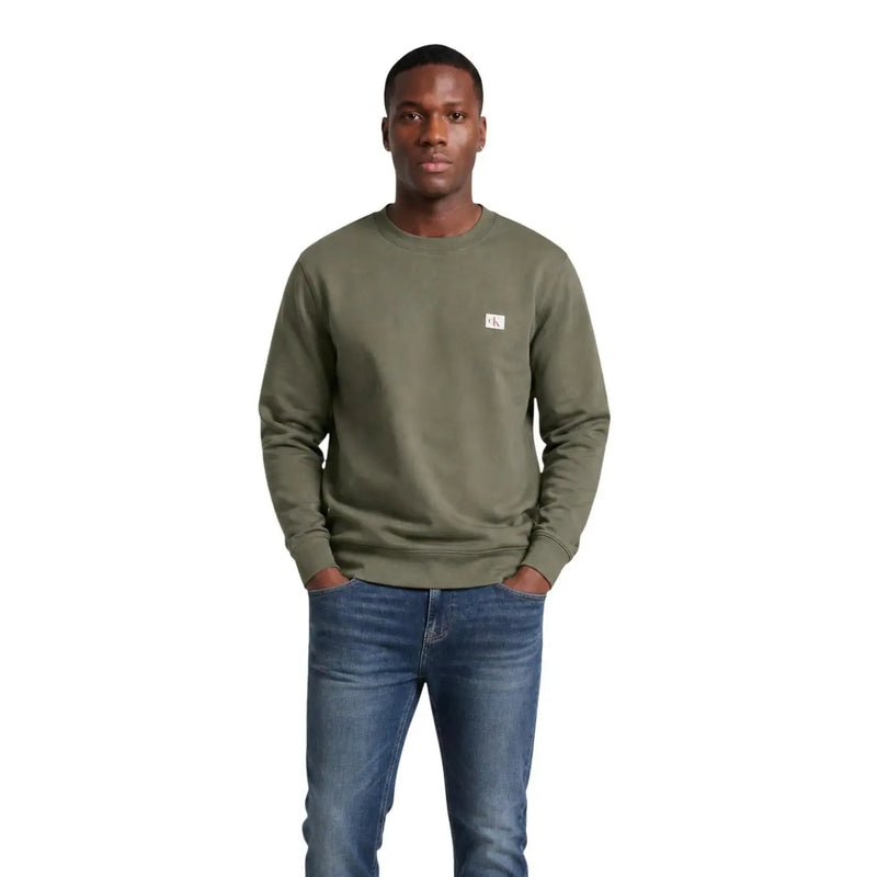 Calvin Klein Jeans Sweat-shirt vert en coton pour homme, col rond, avec un petit logo blanc sur la poitrine gauche.