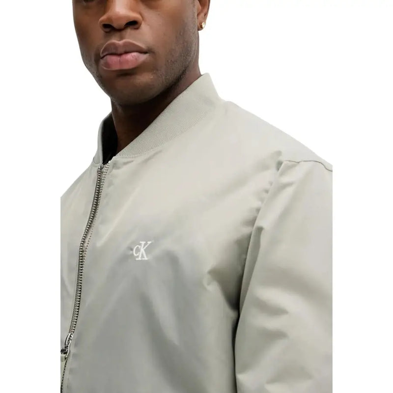 Calvin Klein Jeans Blazer zippé vert en polyamide pour homme, avec une veste bomber gris clair ornée d'un logo brodé blanc discret.