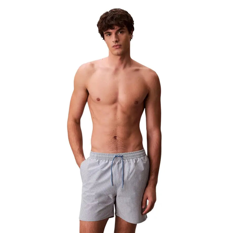 Calvin Klein Jeans men grey medium drawstring swimwear featuring light blue and white striped swim trunks with matching drawstring