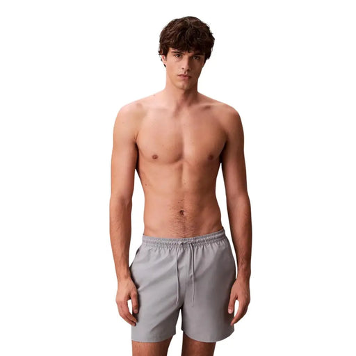 Calvin Klein Jeans Short de bain gris pour homme en polyester, taille M, avec cordon de serrage à la taille pour un confort optimal.