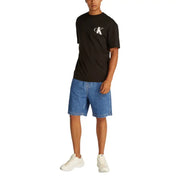 Black calvin klein logo tee shirt with white ck emblem on chest.
