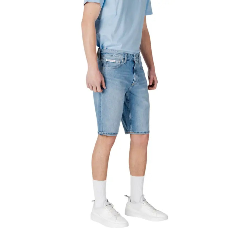 Light blue denim shorts with white socks and sneakers.