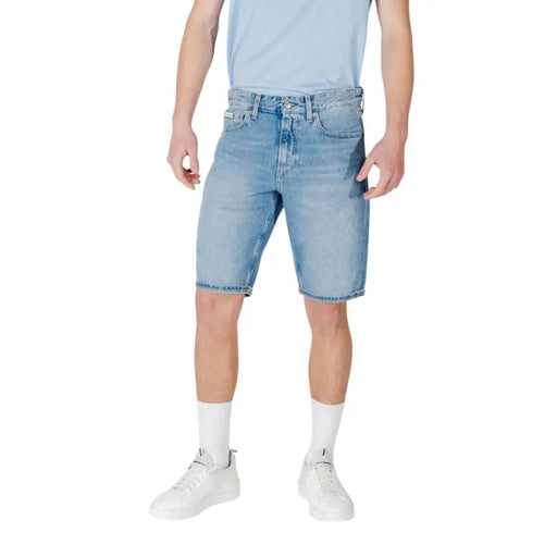 Light blue denim shorts with a faded wash and rolled hem, designed by levi’s.