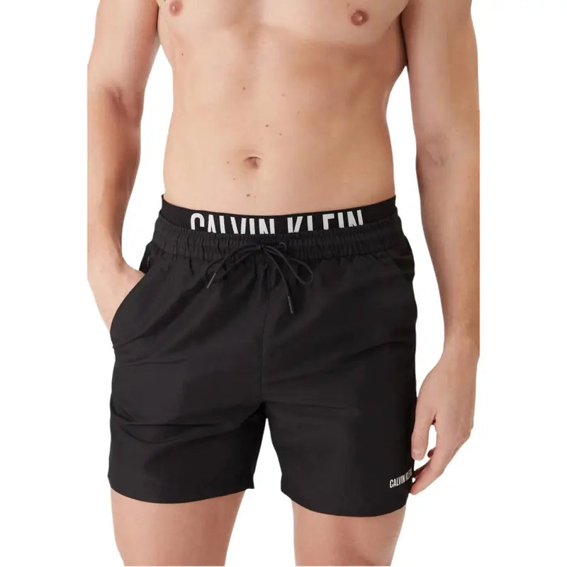 Calvin Klein Jeans men swimwear black swim trunks with white logo branding on waistband and side