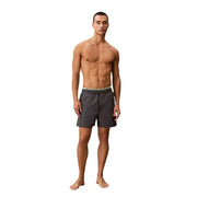 Dark gray calvin klein jeans men swimwear swim trunks with light green elastic waistband featuring brand logo