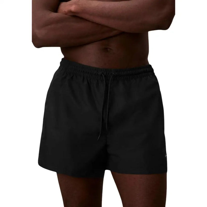 Calvin Klein Jeans men swimwear black athletic shorts with elastic waistband and drawstring made of lightweight fabric