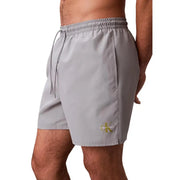 Gray Calvin Klein Jeans men swimwear swim trunks with subtle gold logo on lower leg for beach and pool use