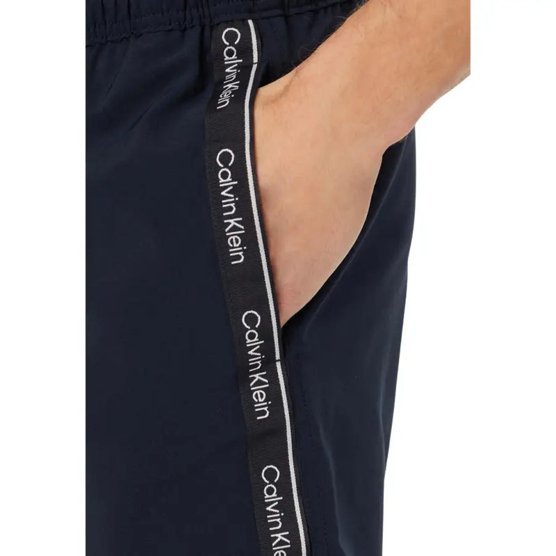 Dark navy calvin klein jeans men swimwear track pants with black and white branded side stripe for casual wear