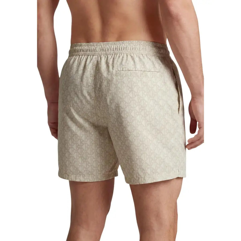 Beige calvin klein jeans men swimwear swim trunks with a subtle repeating geometric pattern suitable for swimming