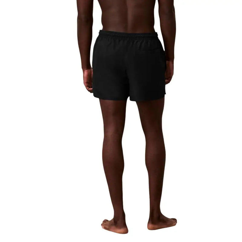 Black Calvin Klein Jeans men swimwear athletic swim trunks with elastic waistband designed for swimming use