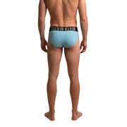 Light blue calvin klein jeans men swimwear briefs with black waistband and white brand lettering