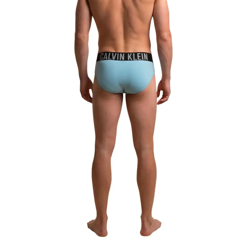 Light blue calvin klein jeans men swimwear briefs with black waistband and white brand lettering