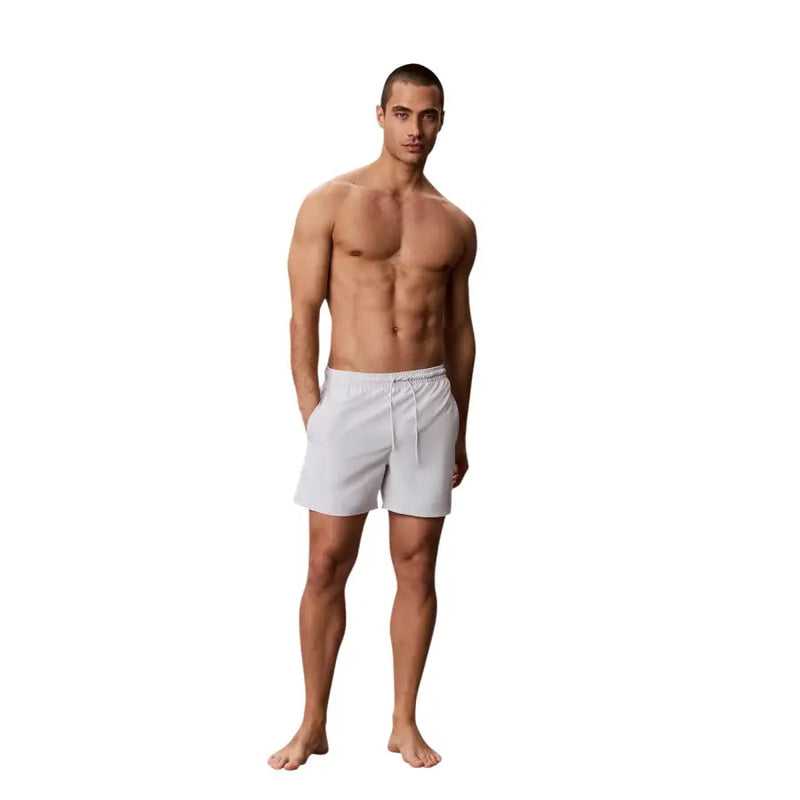 White Calvin Klein Jeans men swimwear athletic shorts with drawstring waistband for beach and pool use