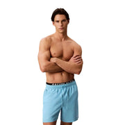 Light blue calvin klein jeans men swimwear swim trunks with black waistband and drawstring for swimming use