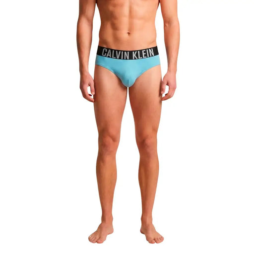 Light blue calvin klein jeans men swimwear briefs with black waistband and white logo lettering