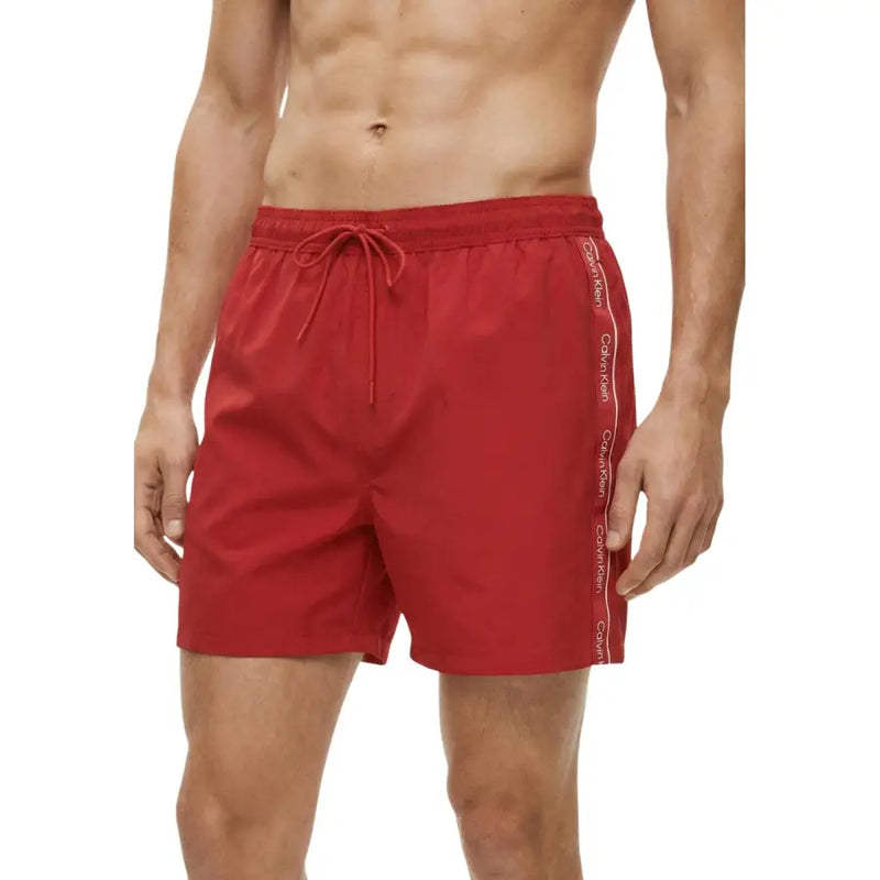 Red Calvin Klein Jeans men swimwear swim trunks featuring a white logo stripe along the side