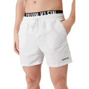 White calvin klein jeans men swimwear swim trunks with black elastic waistband and embroidered logo on lower right leg