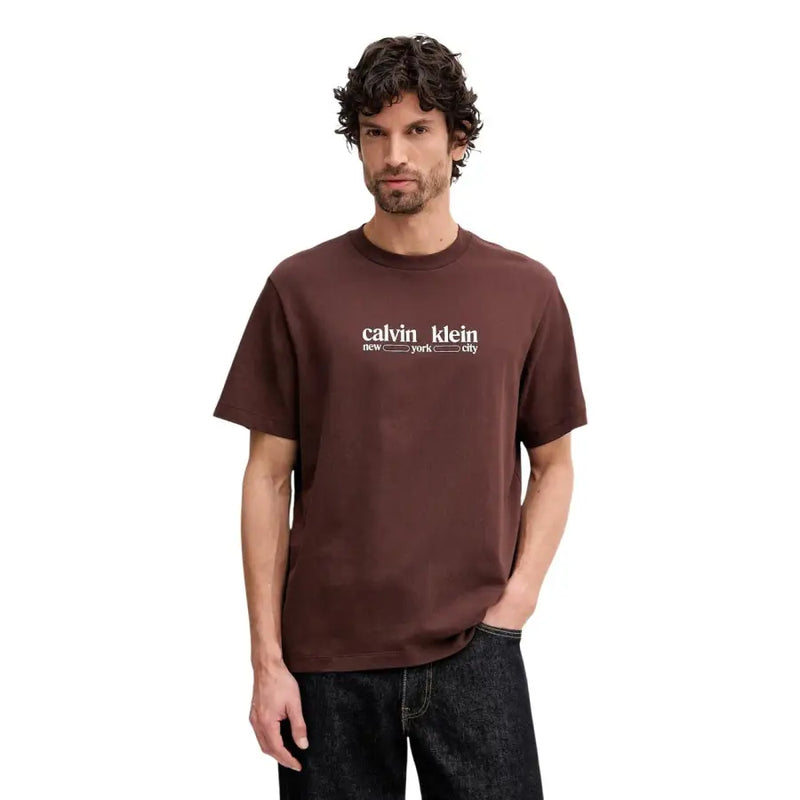 Brown calvin klein t-shirt with white calvin klein new york city logo printed on cotton short sleeve fabric