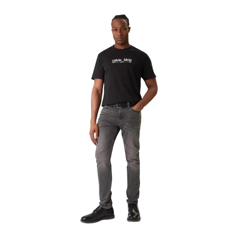 Black Calvin Klein Jeans men t shirt made of cotton with short sleeves and white logo on front in black color