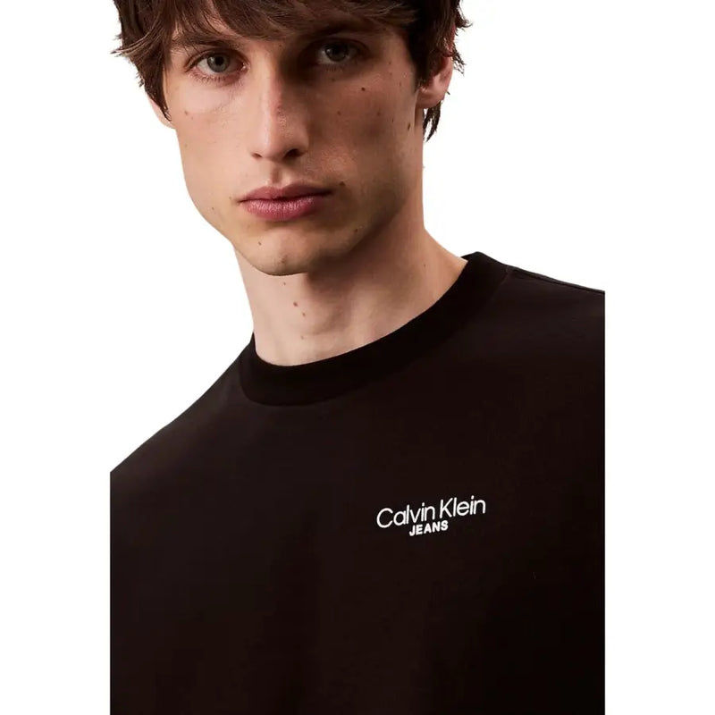 Calvin Klein Jeans T-shirt homme en coton noir avec logo brodé blanc sur la poitrine, idéal pour une tenue décontractée.