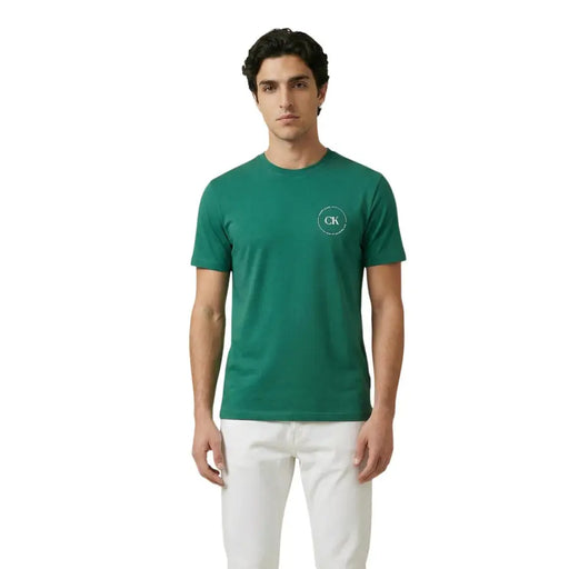 Green short-sleeved cotton t-shirt with white circular logo on left chest by Calvin Klein Jeans for men