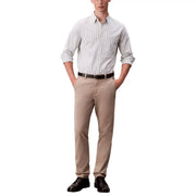 Un homme portant un pantalon chino beige à manches retroussées et des chaussures noires avec Calvin Klein Jeans pantalon noir en coton élasthanne