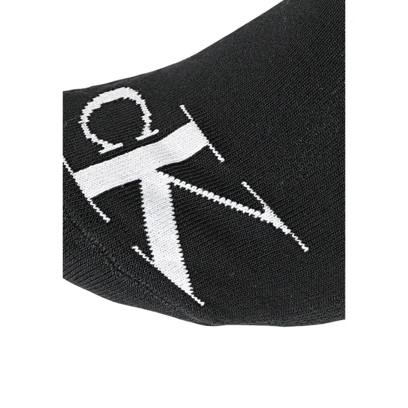 Noir Calvin Klein chaussettes ornées d'un logo CK blanc audacieux tricoté dans le tissu, destinées à être portées comme sous-vêtements pour hommes