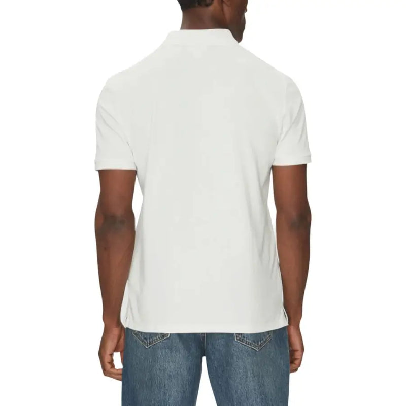 Tommy hilfiger men’s white polo shirt with distressed denim jeans.