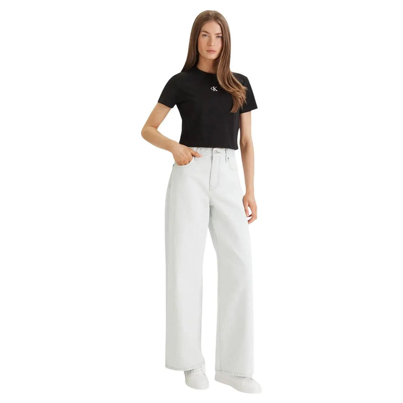 White wide-leg denim jeans paired with a Calvin Klein Jeans women black cotton round neck t shirt front view