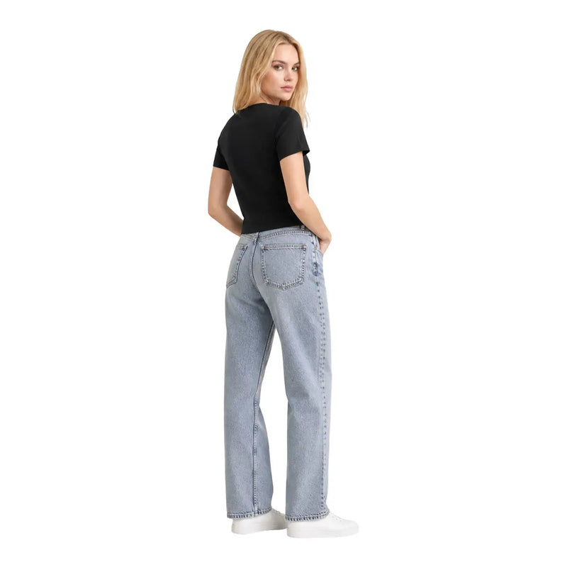 T-shirt court classique en coton noir Calvin Klein Jeans pour femme, présenté avec un jean en denim délavé clair (vue de dos).