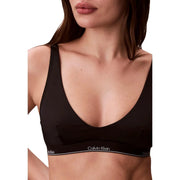 Calvin Klein Jeans Soutien-gorge dos nu noir pour femme, au design minimaliste et élégant, avec un logo blanc discret sur la bande.