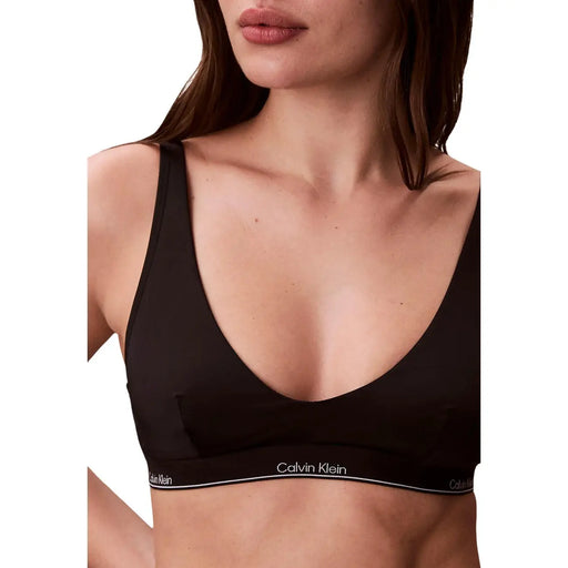 Calvin Klein Jeans Soutien-gorge dos nu noir pour femme, au design minimaliste et élégant, avec un logo blanc discret sur la bande.